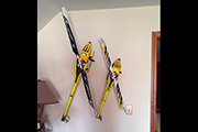 RC Helicopters mounted on wall as art.  Random Heli Skid Clamps hold models on angles