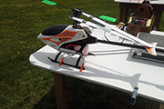 Skid Clamps hold RC helicopter on table at flying field