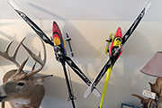 RC Helicopters mounted on wall as art.  Random Heli Skid Clamps hold models on angles