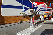Random Heli Gear Jacks Tail Support mounted on Gladiator Gear Track in cargo trailer