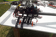 Skid Clamps hold RC helicopter on table at flying field