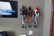 Three large RC Helicopters mounted on a wall using Random Heli Skid Clamps