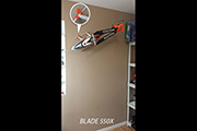Blade 550X RC helicopter mounted to wall using Random Heli Skid Clamps