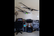 Synergy RC helicopters mounted on wall diagonally using Random Heli Skid Clamps