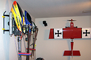 Several RC helicopters mounted to wall using Skid Clamps